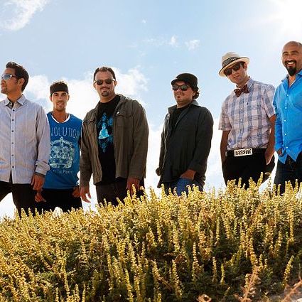 A group of men standing in a field.